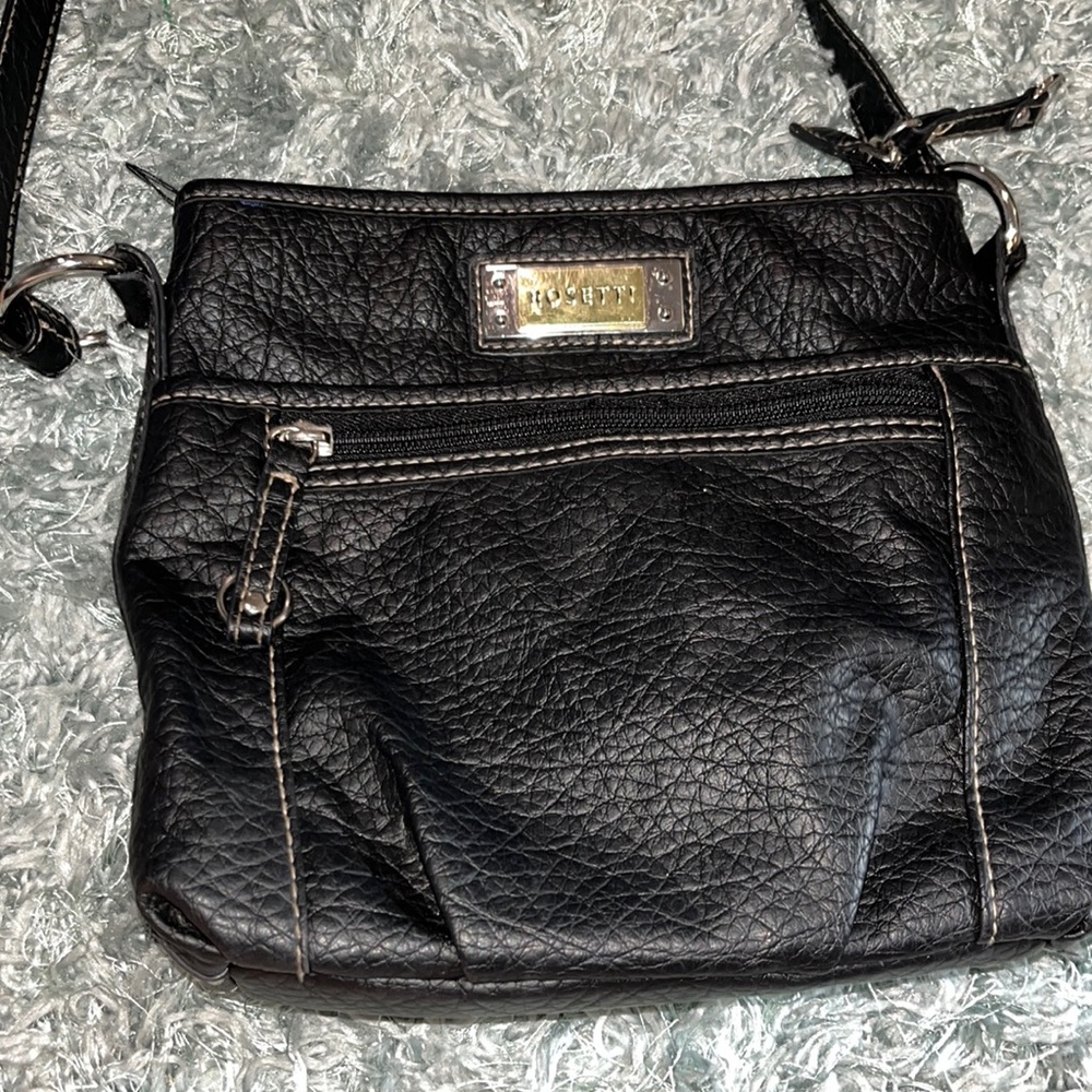 A black leather rosetti purse